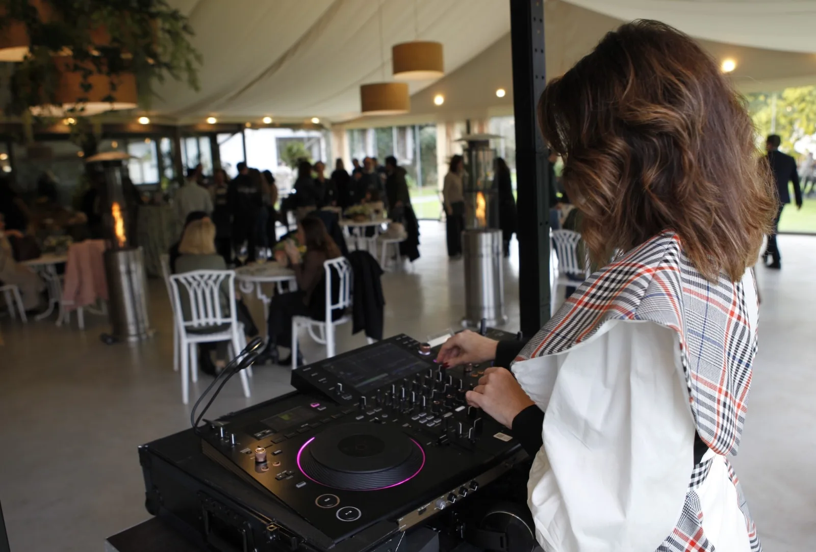 DJ María Martín on Pioneer booth during a marquee corporate event